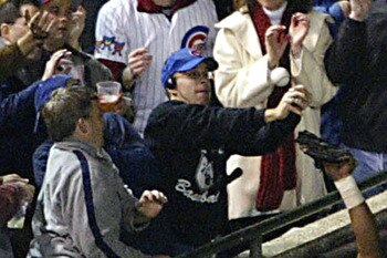 CHICAGO - OCTOBER 14:  Fans interfere with outfielder Moises Alou #18 of the Chicago Cubs on a ball hit by Luis Castillo #1 of the Florida Marlins in the eighth inning during Game 6 of the National League Championship Series October 14, 2003 at Wrigley Fi