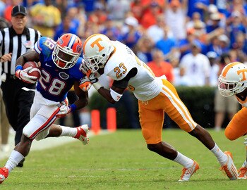 GAINESVILLE, FL - SEPTEMBER 17:  Running back Jeff Demps #28 of the Florida Gators attempts tu run past defensive back Prentiss Waggner #23 of the Tennessee Volunteers during a game at Ben Hill Griffin Stadium on September 17, 2011 in Gainesville, Florida