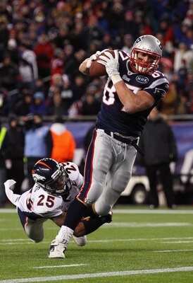 FOXBORO, MA - JANUARY 14:  Rob Gronkowski #87 of the New England Patriots scores a 12-yard touchdown reception in the seocnd quarter against Chris Harris #25 of the Denver Broncos during their AFC Divisional Playoff Game at Gillette Stadium on January 14,