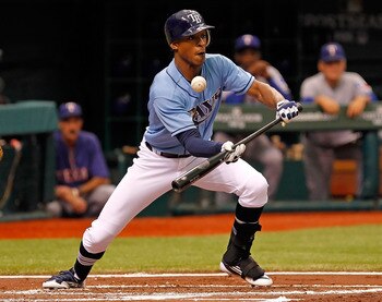 ST. PETERSBURG - OCTOBER 04:  Oufielder B.J. Upton #2 of the Tampa Bay Rays attempts a bunt against the Texas Rangers during Game Four of the American League Division Series at Tropicana Field on October 4, 2011 in St. Petersburg, Florida.  (Photo by J. M