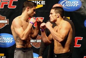 Carlos Condit (left) squaring off with Jake Ellenberger/ photo cred: MMAJunkie.com