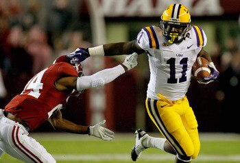 TUSCALOOSA, AL - NOVEMBER 05:  Spencer Ware #11 of the LSU Tigers pushes away DeQuan Menzie #24 of the Alabama Crimson Tide during the first quarter of the game at Bryant-Denny Stadium on November 5, 2011 in Tuscaloosa, Alabama.  (Photo by Streeter Lecka/
