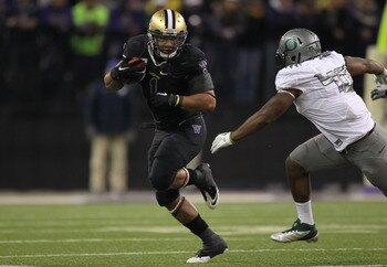 SEATTLE - NOVEMBER 05:  Running back Chris Polk #1 of the Washington Huskies rushes against Michael Clay #46 of the Oregon Ducks on November 5, 2011 at Husky Stadium in Seattle, Washington. Oregon won 34-17. (Photo by Otto Greule Jr/Getty Images)