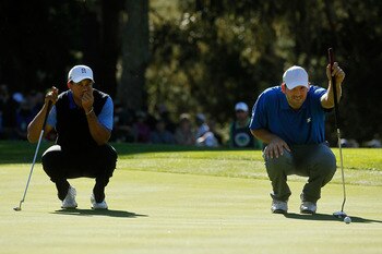 Tony Romo (R) pictured with Tiger Woods