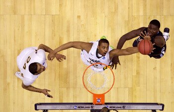 CLEVELAND, OH - MARCH 18: Ryan Pearson #24 of the George Mason Patriots and Mouphtaou Yarou #13 of the Villanova Wildcats go up for a rebound during the second round of the 2011 NCAA men's basketball tournament at Quicken Loans Arena on March 18, 2011 in 