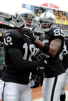 OAKLAND, CA - DECEMBER 18: Louis Murphy #18 and Darrius Heyward-Bey #85 of the Oakland Raiders celebrates after Murphy goes twelve yards on a reverse for a touchdown against the Detroit Lions at O.co Coliseum on December 18, 2011 in Oakland, California.  
