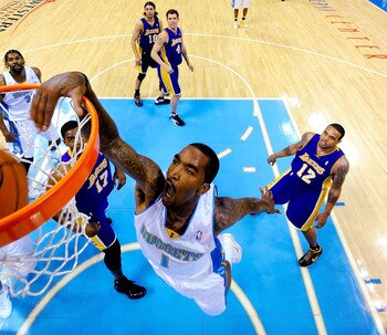 DENVER - MAY 25:  J.R. Smith #1 of the Denver Nuggets dunks the ball over Andrew Bynum #17 of the Los Angeles Lakers in Game Four of the Western Conference Finals during the 2009 NBA Playoffs at Pepsi Center on May 25, 2009 in Denver, Colorado. NOTE TO US