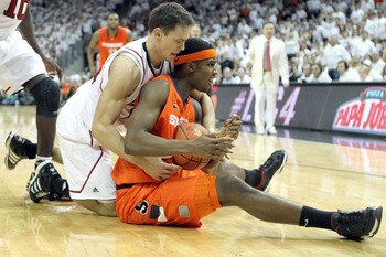 LOUISVILLE, KY - FEBRUARY 13:  C.J. Fair #5 of the Syracuse Orange grabs a loose ball while defended by Kyle Kuric #14 of the Louisville Cardinals during the Big East Conference game at KFC YUM! Center on February 13, 2012 in Louisville, Kentucky.  (Photo