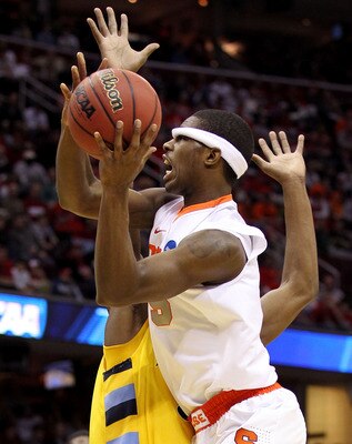 CLEVELAND, OH - MARCH 20: C.J. Fair #5 of the Syracuse Orange drives to the basket as his headband is knocked over his eyes against the Marquette Golden Eagles during the third of the 2011 NCAA men's basketball tournament at Quicken Loans Arena on March 2