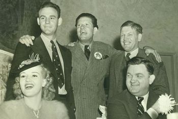 Photo Source: http://www.hogdb.com/wp-content/uploads/2010/11/1939-Betty-Grable-Capt-Lloyd-Woodell-comedian-Bob-Burns-coach-Fred-Thomsen-and-gov-Carl-Bailey.jpg