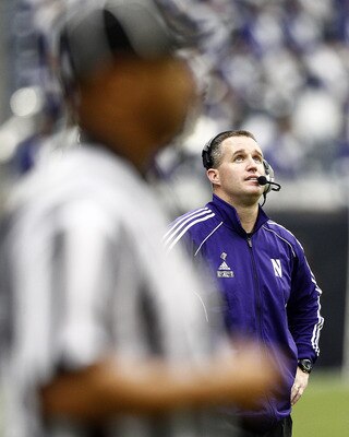 HOUSTON - DECEMBER 31:  Head coach Pat Fitzgerald of the Northwestern Wildcats watches the replay board as the Texas A&M Aggies score in the third quarter at Reliant Stadium on December 31, 2011 in Houston, Texas.  (Photo by Bob Levey/Getty Images)