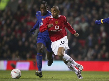 MANCHESTER, ENGLAND - DECEMBER 1:  David Bellion of Manchester United beats Johan Dkorou of Arsenal on his way to scoring the first goal during the Carling Cup match between Manchester United and Arsenal at Old Trafford on December 1 , 2004 in Manchester,