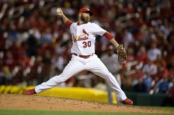 ST. LOUIS, MO - APRIL 17: Jason Motte #30 of the St. Louis Cardinals throws to a Cincinnati Reds batter in the tenth inning at Busch Stadium on April 17, 2012 in St. Louis, Missouri. (Photo by Jeff Curry/Getty Images)