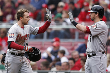 CINCINNATI, OH - APRIL 29: Jed Lowrie #4 of the Houston Astros celebrates with Travis Buck #6 after hitting a two-run home run in the fifth inning against the Cincinnati Reds at Great American Ball Park on April 29, 2012 in Cincinnati, Ohio. The Reds came