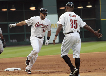 HOUSTON - APRIL 07: J.D. Martinez #14 of the Houston Astros receives congratulations from third base coach Dave Clark after hitting a home run against the Colorado Rockies at Minute Maid Park on April 7, 2012 in Houston, Texas. (Photo by Bob Levey/Getty