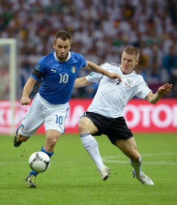 WARSAW, POLAND - JUNE 28: Antonio Cassano (L) of Italy and Bastian Schweinsteiger of Germany battle for the ball during the UEFA EURO 2012 semi final match between Germany and Italy at National Stadium on June 28, 2012 in Warsaw, Poland. (Photo by Claud