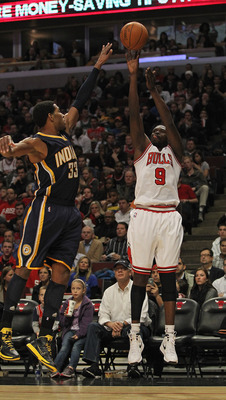 CHICAGO, IL - DECEMBER 20: Loul Deng #9 of the Chicago Bulls puts up a shot against Danny Granger #33 of the Indiana Pacers at the United Center on December 20, 2011 in Chicago, Illinois. The Bulls defeated the Pacers 93-85. NOTE TO USER: User expressly a