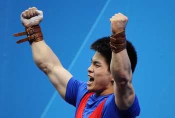 LONDON, ENGLAND - JULY 31:  Qingfeng Lin of China celebrates winning Gold during the Men's 69kg Weightlifting Final on Day 4 of the London 2012 Olympic Games at ExCeL on July 31, 2012 in London, England.  (Photo by Laurence Griffiths/Getty Images)