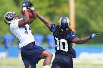 Jalil Carter (14) and Dionte Dinkins (30) compete for control of a pass during training camp at the Russell Training Center on July 31, 2011 in Earth City, Missouri. Many positions are still up for grabs, too.