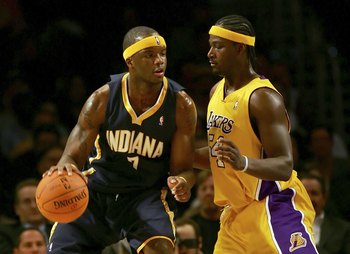 LOS ANGELES - DECEMBER 4: Jermaine O'Neal #7 of the Indiana Pacers drives against Kwame Brown #54 of the Los Angeles Lakers at Staples Center December 4, 2006 in Los Angeles, California. NOTE TO USER: User expressly acknowledges and agrees that, by down