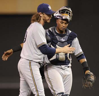 MINNEAPOLIS, MN - JUNE 15: John Axford #59 and Martin Maldonado #12 of the Milwaukee Brewers celebrate a win against the Minnesota Twins on June 15, 2012 at Target Field in Minneapolis, Minnesota. The Brewers defeated the Twins 5-3. (Photo by Hannah Fosl