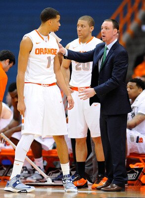Assistant coach Gerry McNamara advises Michael Carter-Williams as Brandon Triche looks on.