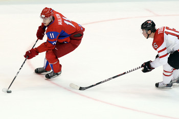 Hi-res-97033385-evgeny-malkin-of-russia-controls-the-puck-as-shea-weber_display_image