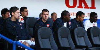 PORTSMOUTH, UNITED KINGDOM - MAY 02: (L-R) Fran Marida, Mark Randall, Vito Mannone, Amaury Bischoff, Jay Thomas, Francis Coquelin and Emmanuel Frimpong of Arsenal look on from the bench prior to the Barclays Premier League match between Portsmouth and Ar