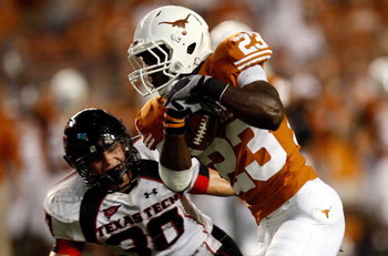 AUSTIN, TX - SEPTEMBER 19: Running back Tre' Newton #23 of the Texas Longhorns runs for a touchdown against Brett Dewhurst #30 of the Texas Tech Red Raiders at Darrell K Royal-Texas Memorial Stadium on September 19, 2009 in Austin, Texas. (Photo by Rona
