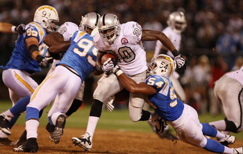 OAKLAND, CA - SEPTEMBER 14: Darren McFadden #20 of the Oakland Raiders runs the ball against Stephen Cooper #54 of the San Diego Chargers on September 14, 2009 at the Oakland-Alameda County Coliseum in Oakland, California. (Photo by Ezra Shaw/Getty Imag