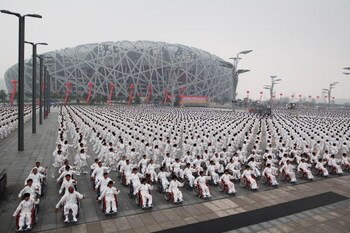 BEIJING - AUGUST 08:  33,996 people take part in an attempt to break the Guinness world record for the largest number of people practising Taiji outside the National Olympic Stadium, known as the Bird's Nest on August 8, 2009 in Beijing, China. China hold