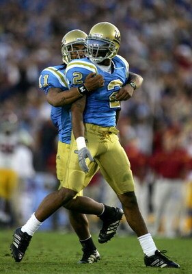 PASADENA, CA - DECEMBER 02:  Eric McNeal #2 of the UCLA Bruins celebrates with teammate Dennis Keyes #11 after intercepting the ball in the fourth quarter in the game against the USC Trojans on December 2, 2006 at the Rose Bowl in Pasadena, California. Th