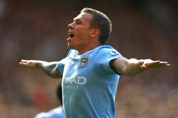 MANCHESTER, ENGLAND - SEPTEMBER 20:  Craig Bellamy of Manchester City celebrates scoring his team's second goal during the Barclays Premier League match between Manchester United and Manchester City at Old Trafford on September 20, 2009 in Manchester, Eng