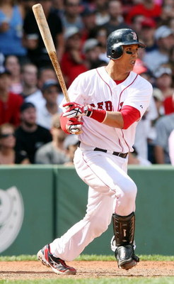 BOSTON - SEPTEMBER 13: Victor Martinez #41 of the Boston Red Sox hits an RBI single in the sixth inning against the Tampa Bay Rays on September 13, 2009 at Fenway Park in Boston, Massachusetts. (Photo by Elsa/Getty Images)