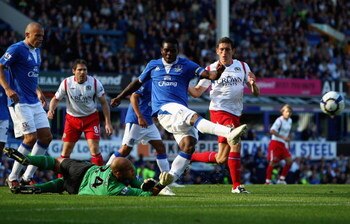LIVERPOOL, ENGLAND - SEPTEMBER 20:  Joseph Yobo of Everton clears a dangerous ball as his keeper Tim Howard watches on during the Barclays Premier League match between Everton and Blackburn Rovers at Goodison Park on September 20, 2009 in Liverpool, Engla