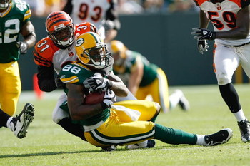 GREEN BAY, WI - SEPTEMBER 20: Tight end Jermichael Finley #88 of the Green Bay Packers is tackled by defensive back Roy Williams #31 of the Cincinnati Bengals at Lambeau Field on September 20, 2009 in Green Bay, Wisconsin. The Bengals defeated the Packers