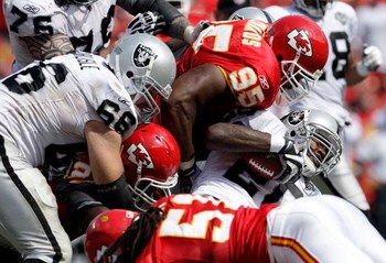 KANSAS CITY, MO - SEPTEMBER 20:  Darren McFadden #20 of the Oakland Raiders runs up the middle as Ron Edwards #95 of the Kansas City Chiefs defends during the game at Arrowhead Stadium on September 20, 2009 in Kansas City, Missouri.  (Photo by Jamie Squir