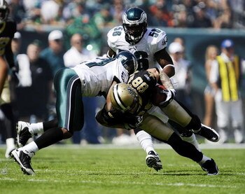 PHILADELPHIA - SEPTEMBER 20:  Sean Jones #26 and Akeem Jordan #56 of the Philadelphia Eagles take down Jeremy Shockey #88 of the New Orleans Saints during their game at Lincoln Financial Field on September 20, 2009 in Philadelphia, Pennsylvania.  (Photo b