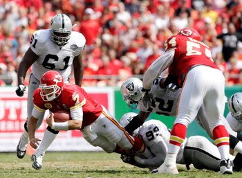 KANSAS CITY, MO - SEPTEMBER 20:  Quarterback Matt Cassel #7 of the Kansas City Chiefs is sacked by Kirk Morrison #52 and Greg Ellis #99 of the Oakland Raiders during the game at Arrowhead Stadium on September 20, 2009 in Kansas City, Missouri.  (Photo by 