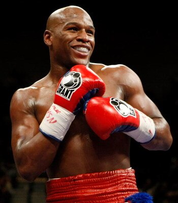 LAS VEGAS - SEPTEMBER 19:  Floyd Mayweather Jr. smiles in the ring during his fight against Juan Manuel Marquez at the MGM Grand Garden Arena September 19, 2009 in Las Vegas, Nevada. Mayweather won by unanimous decision.  (Photo by Ethan Miller/Getty Imag