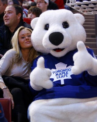 MONTREAL - JANUARY 24:  Carlton the Bear, the mascot of the Toronto Maple Leafs, hams it up with a fan at the Honda / NHL SuperSkills at Bell Center as part of the 2009 NHL All-Star Weekend festivities on January 24, 2009 in Montreal, Canada.  (Photo by P