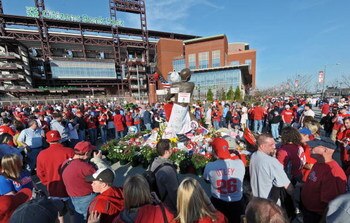 PHILADELPHIA - APRIL 17: Philadelphia Phillies fans gather around a make-shift memorial dedicated to recently departed Philadelphia Phillies announcer Harry Kalas outside of Citizens Bank park before the game against the San Diego Padres on April 17, 2009