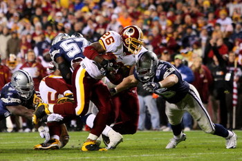 LANDOVER, MD - NOVEMBER 16: Clinton Portis #26 of the Washington Redskins runs against Zach Thomas #55 of the Dallas Cowboys during the first quarter of their game on November 16, 2008 at FedEx Field in Landover, Maryland. (Photo by Jim McIsaac/Getty Im