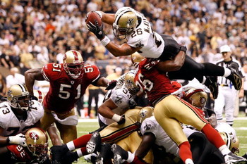 NEW ORLEANS - SEPTEMBER 28: Deuce McAllister #26 of the New Orleans Saints scores a touchdown over Mark Roman #26 of the San Francisco 49ers on September 28 2008 at the Superdome in New Orleans, Louisiana. The Saints defeated the 49ers 31-17. (Photo by