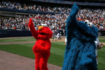 NEW YORK - AUGUST 09: Sesame Street's Elmo and Cookie Monster mascots wave to fans the first 'Mets Shoelace Day' at Shea Stadium on August 9, 2007 in the Queens borough of New York City. (Photo by Bryan Bedder/Getty Images)