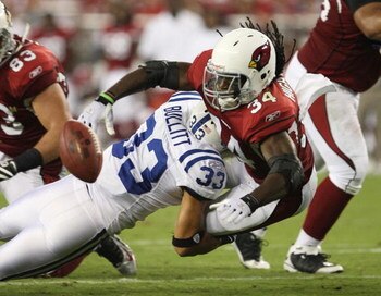 GLENDALE, AZ - SEPTEMBER 27:  Running back Tim Hightower #34 of the Arizona Cardinals fumbles as he is hit by Melvin Bullitt #33 of the Indianapolis Colts in the second quarter during the game at University of Phoenix Stadium on September 27, 2009 in Glen