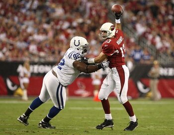 GLENDALE, AZ - SEPTEMBER 27:  Quarterback Kurt Warner #13 of the Arizona Cardinals pushes back Ed Johnson #92 of the Indianapolis Colts to avoid a sack in the first quarter during the game at University of Phoenix Stadium on September 27, 2009 in Glendale