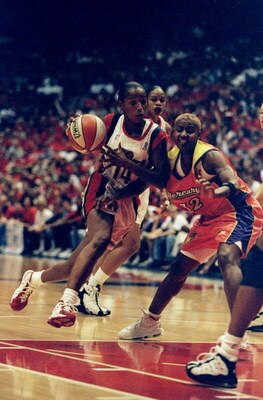 1 Sep 1998:  Guard Cynthia Cooper #14 of the Houston Comets in action against guard Bridget Pettis #32 of the Phoenix Mercury during game three of the WNBA Finals at the Compaq Center in Houston, Texas. The Comets defeated the Mercury 80-71. Mandatory Cre