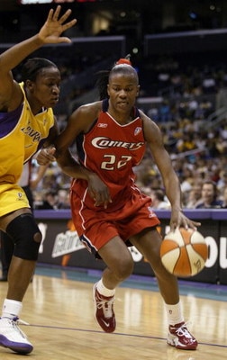 LOS ANGELES - AUGUST 25:  Sheryl Swoopes #22 of the Houston Comets drives to the basket past Mwadi Mabika#4 of the Los Angeles Sparks on August 25, 2003 at Staples Center in Los Angeles, California.  The Sparks won 67-84.  NOTE TO USER: User expressly ack