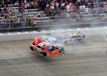 DOVER, DE - SEPTEMBER 27:  (L-R) Joey Logano, driver of the #20 Home Depot Toyota, flips his car after he was involved in a wreck with Reed Sorenson, driver of the #43 Valvoline Dodge, Robby Gordon, driver of the #7 Camping World Toyota and Martin Truex J